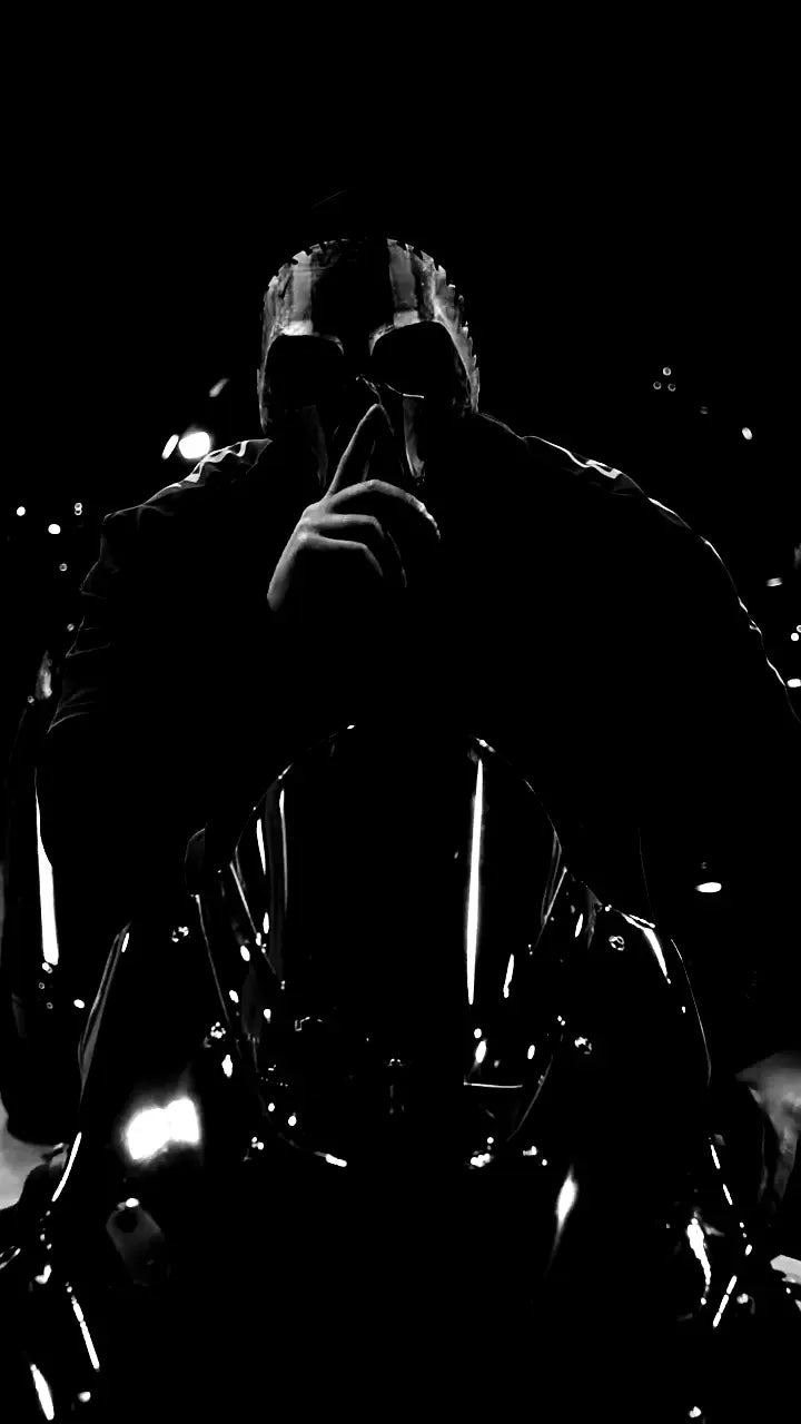 A rider in a skull mask holds a finger to his lips.
